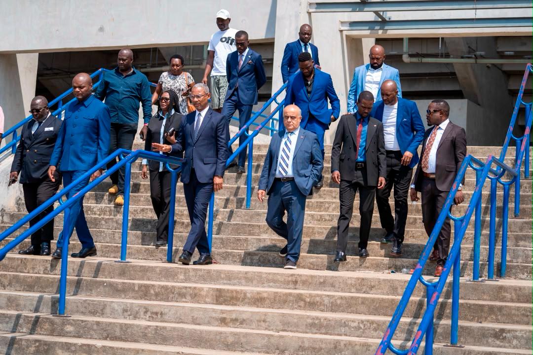 Group on a stadium pitch, according to the caption technical teams at Omar Bongo Stadium.