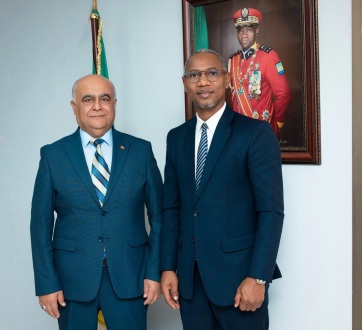 Two men posing together, according to the caption minister Paul Kessany and Numan Hatipoglu.